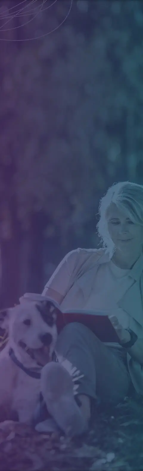 woman reading a book next to her dog for mobile